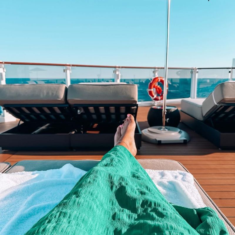 A woman relaxing on a lounger on a cruise ship